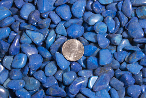 tumbled dyed blue howlite with quarter to show size