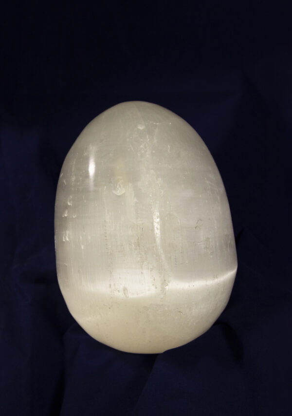 Large egg-shaped selenite stone upright