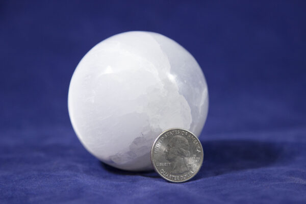 selenite orb with quarter to scale