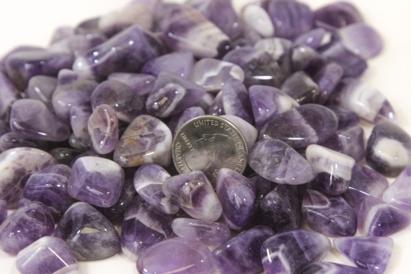 Pile of Tumbled Amethyst Crystals with quarter for size comparison