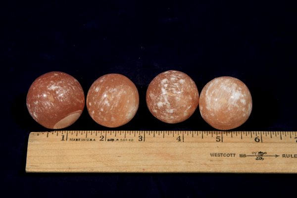 Orange Selenite Orbs with ruler to show size