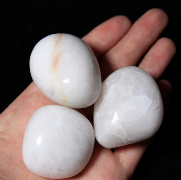 Three Large Tumbled White Agate in hand for size