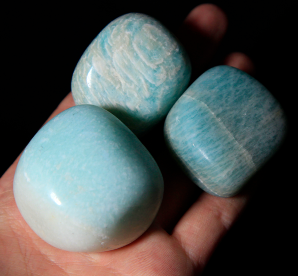 Three Large Tumbled Amazonite in hand for size