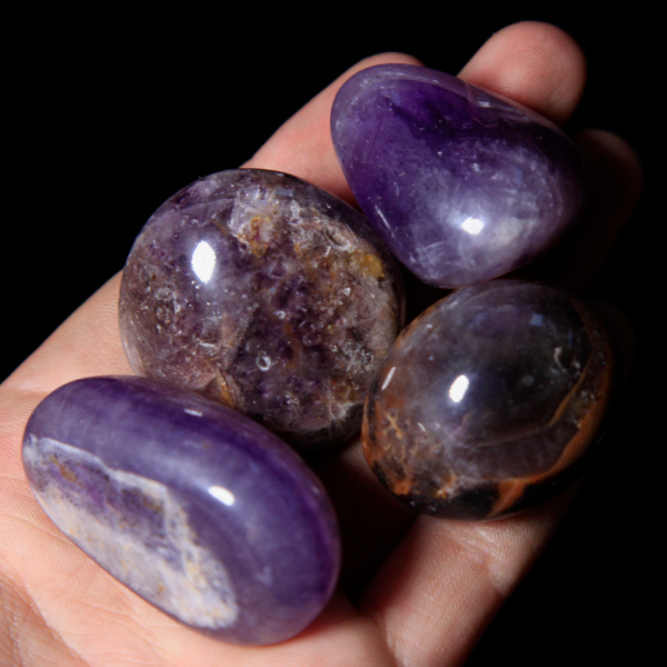 Medium Tumbled Amethyst Pieces in hand for size