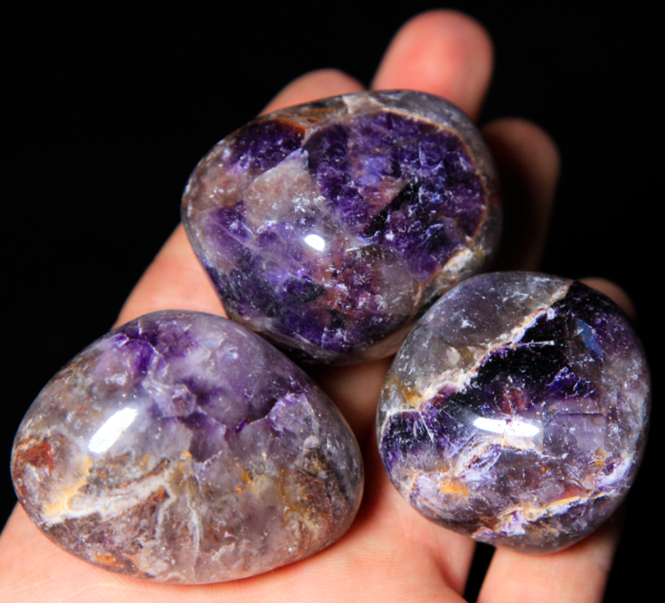 Large Tumbled Amethyst Pieces in hand for size