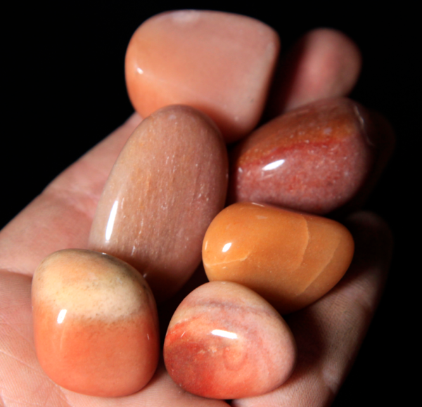 Small Tumbled Pink Aventurine Pieces in hand for size
