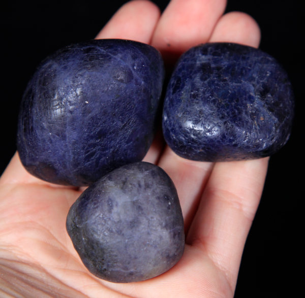 Large Tumbled Iolite Pieces in hand for size