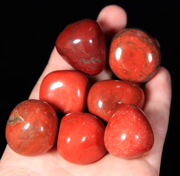 Small Tumbled Red Jasper Pieces in hand for size