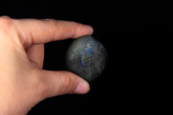Large Labradorite Stone Between Fingers for size comparison