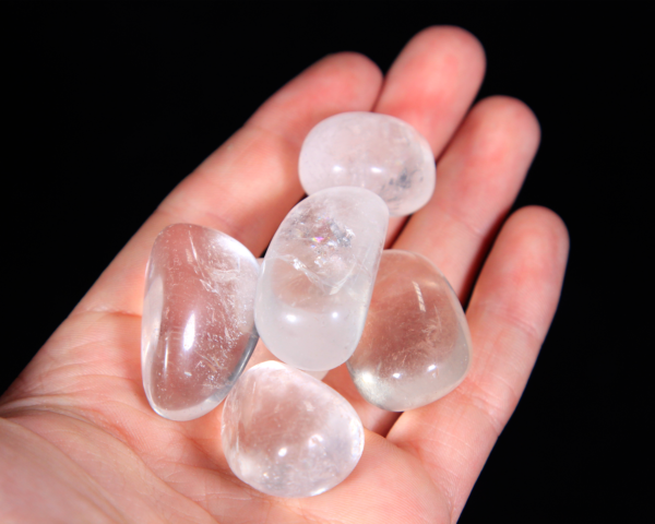 Small Tumbled Clear Quartz Pieces in hand for size