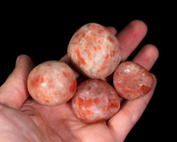 Medium Tumbled Sunstone Pieces in hand for size