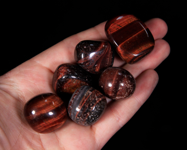 Small Tumbled Red Tiger Eye Pieces in hand for size