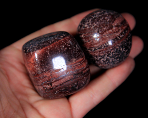 Large Tumbled Red Tiger Eye Pieces in hand for size