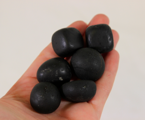 Small Tourmaline Stones in hand for size comparison