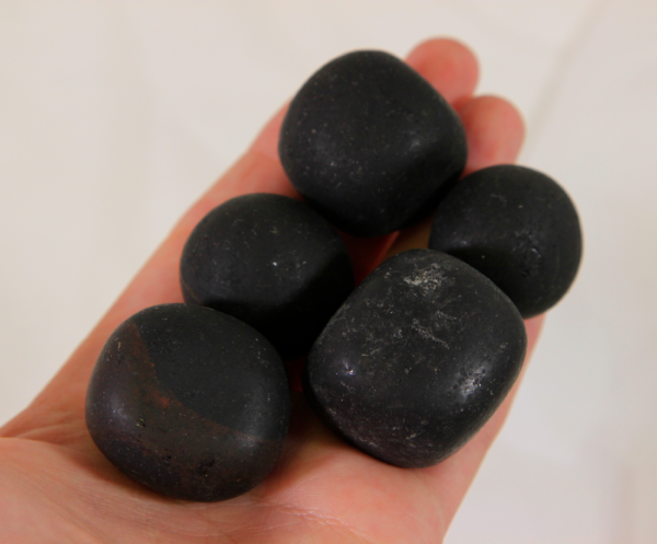 Medium Tourmaline Stones in hand for size comparison