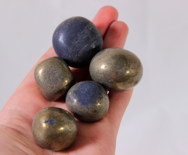 Medium Pyrite Stones in hand for size comparison