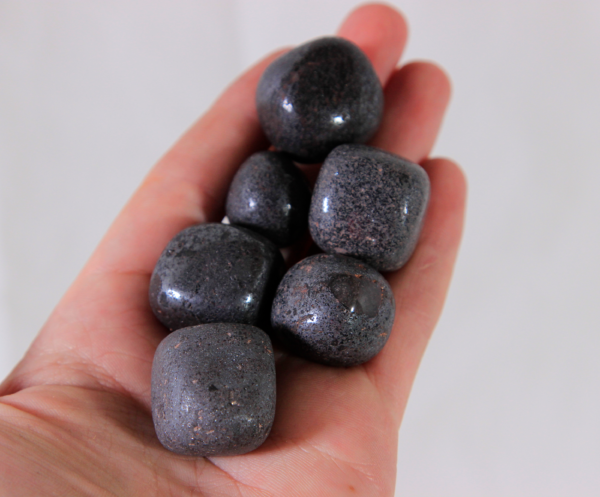 Small Hematite Stones in hand for size comparison