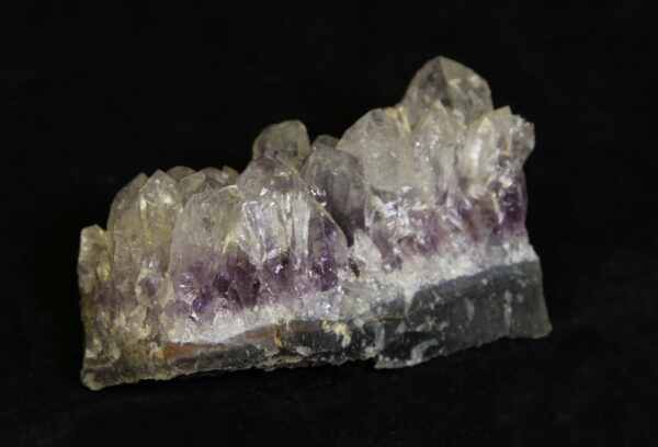 White and purple Amethyst Crystal Cluster embedded in green rock matrix