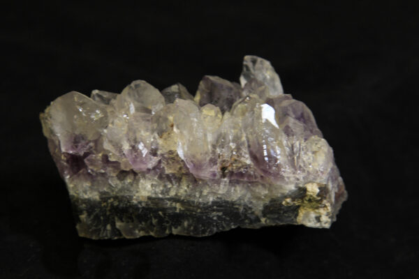White and purple Amethyst Crystal Cluster embedded in green rock matrix