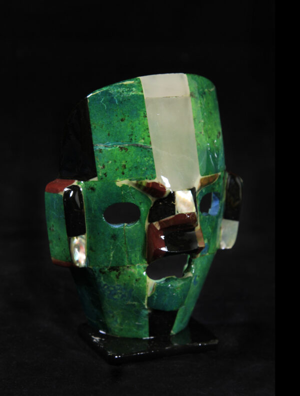 Green decorative crystal mask on stand