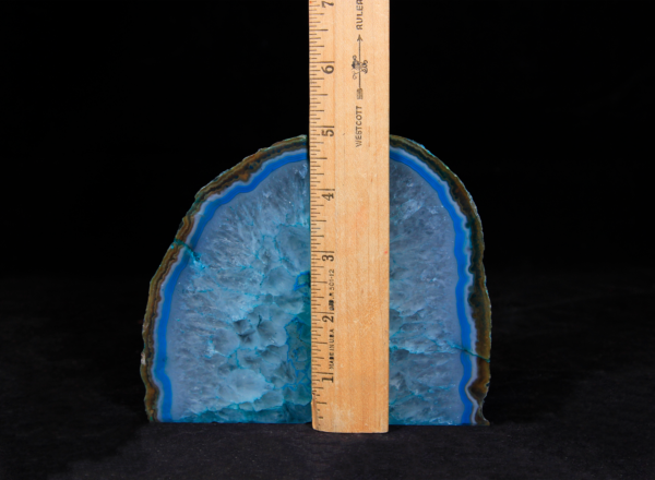 Pair of matching small teal Agate bookends next to ruler to show height