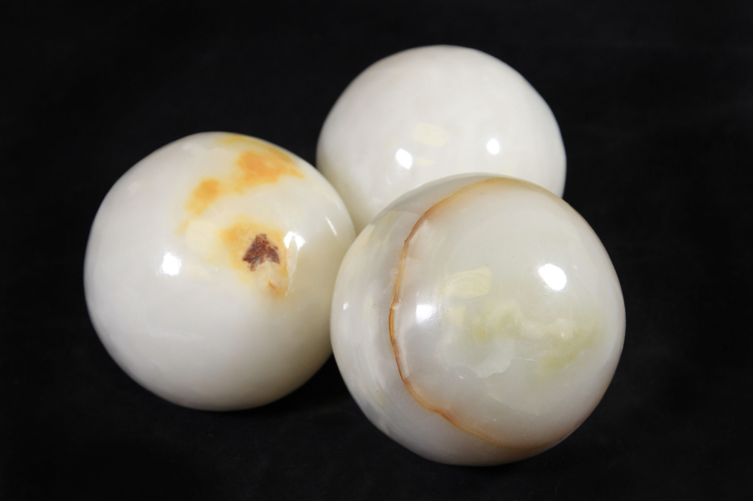 Three egg-shaped onyx marbles