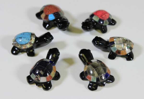 Six obsidian turtle figurines with assorted colored shells