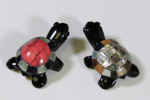 Two Obsidian turtle figurines with assorted multi-colored shells