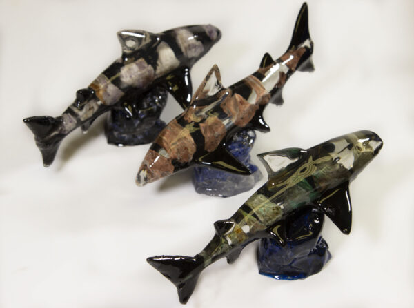 Three assorted mineral shark figurines