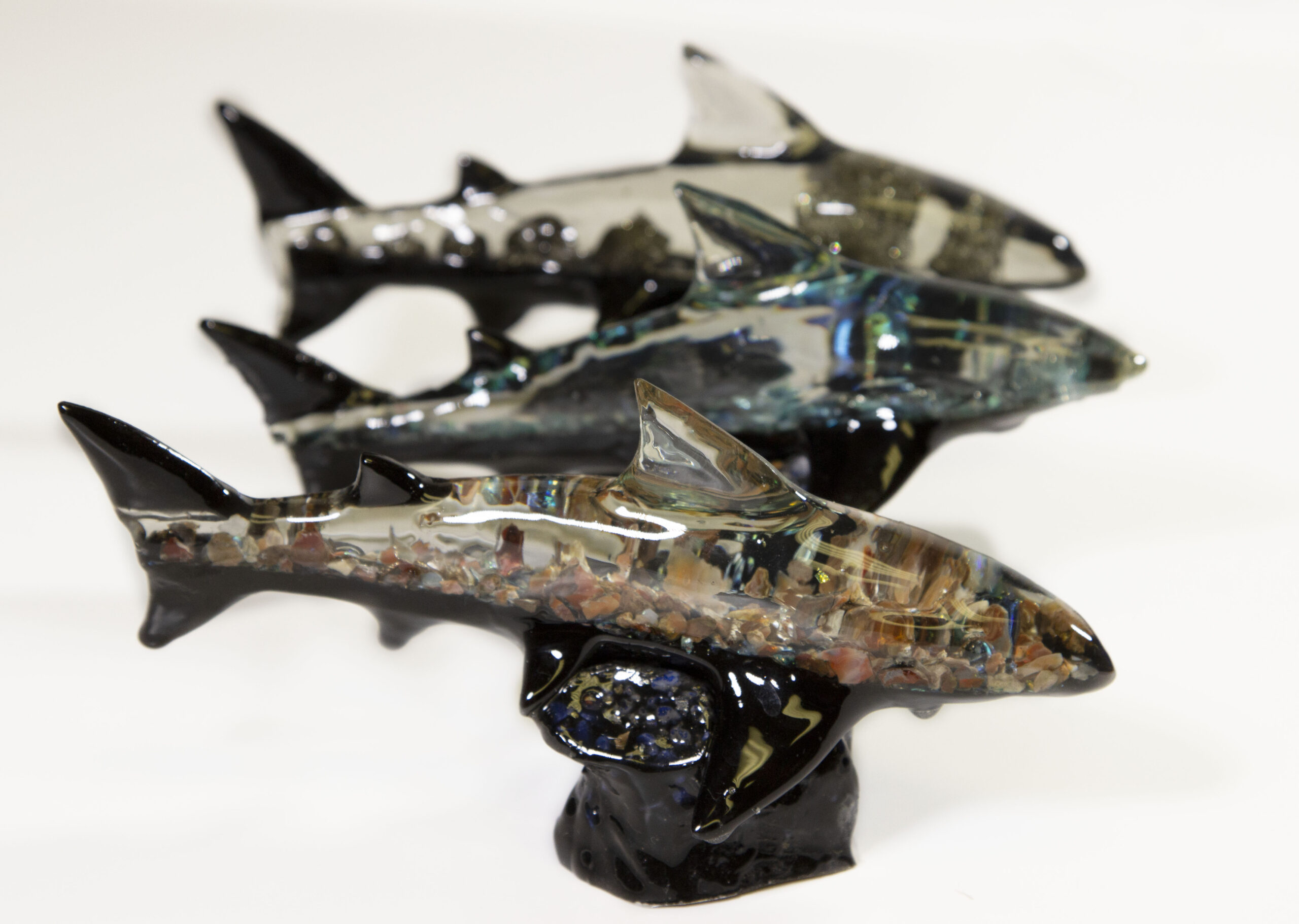 Three assorted mineral shark figurines