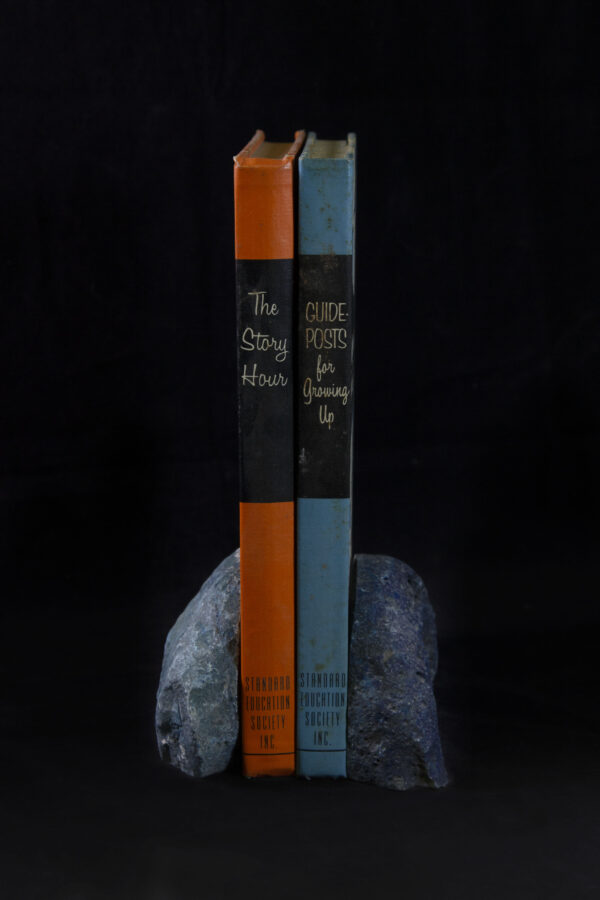 Two Colored Agate Gem Ends holding up books