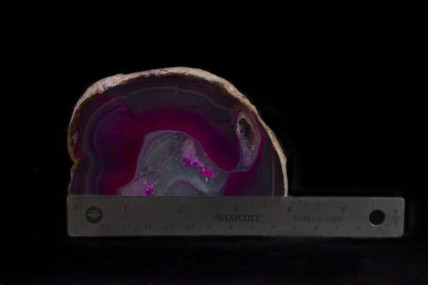 Pink and Purple Colored Agate Gem End next to ruler