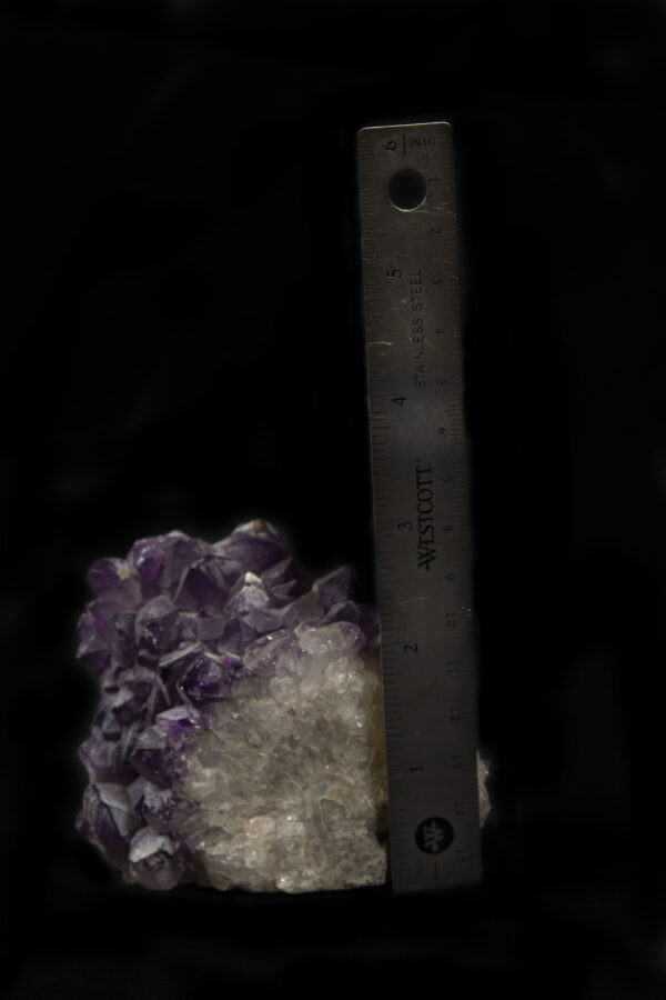 Rounded Purple Amethyst Crystal Cluster with white crystal matrix next to ruler