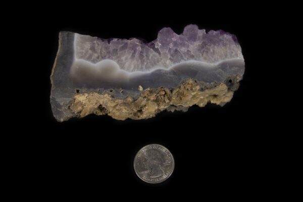 Side view of Purple Amethyst Crystal Slab next to quarter for size comparison