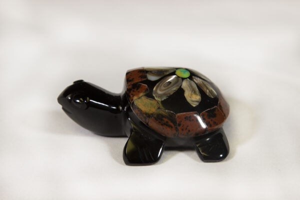 Small black decorative turtle with red and green shell