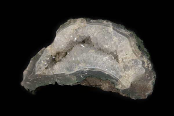 White Amethyst embedded in a deep green and brown rock matrix