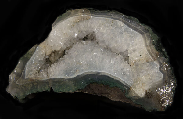 White Amethyst embedded in a deep green and brown rock matrix