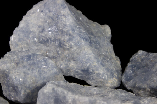 1 to 2 pound Blue Calcite pieces view close up of gem in back