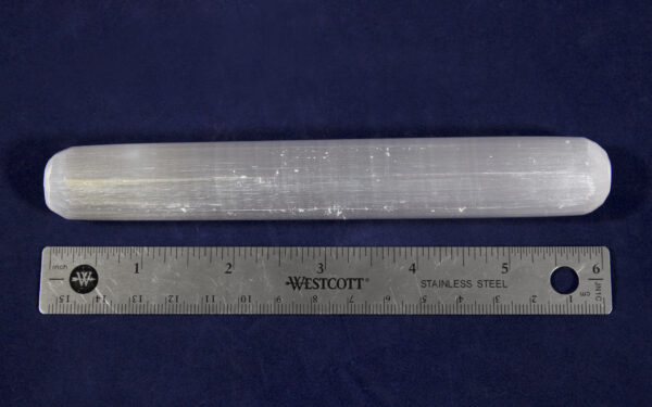 Selenite Crystal Massage Wands next to ruler to show width