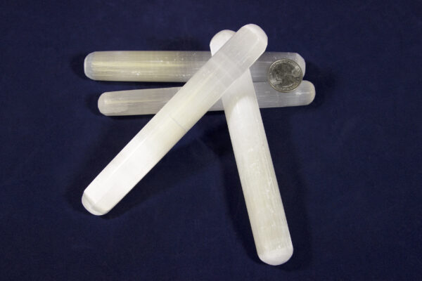 Selenite Crystal Massage Wands with coin for size comparison