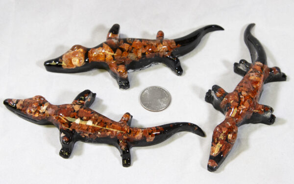 Red Precious Mineral Alligator Figurines next to quarter for size comparison
