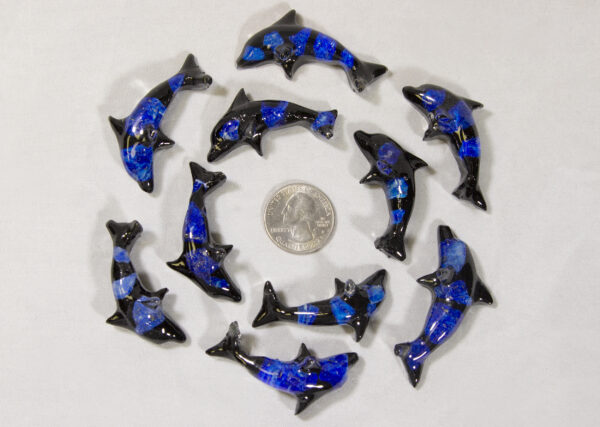 Baby Dark Blue Precious Mineral Dolphin Figurines next to quarter for size comparison