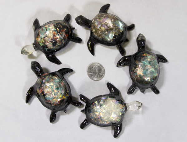 Large Rainbow Precious Mineral Turtle Figurines next to quarter for size comparison