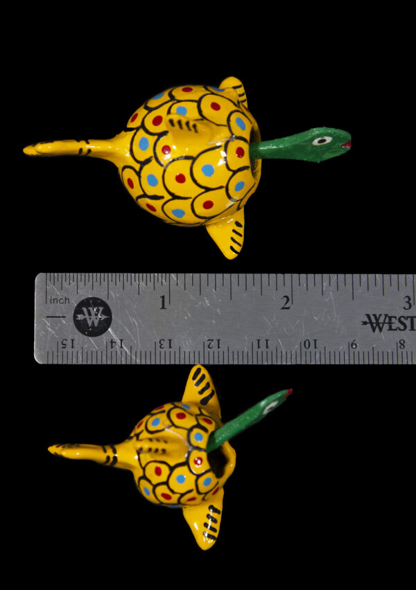 Two Yellow Looseneck Whale Figurines next to ruler for size comparison