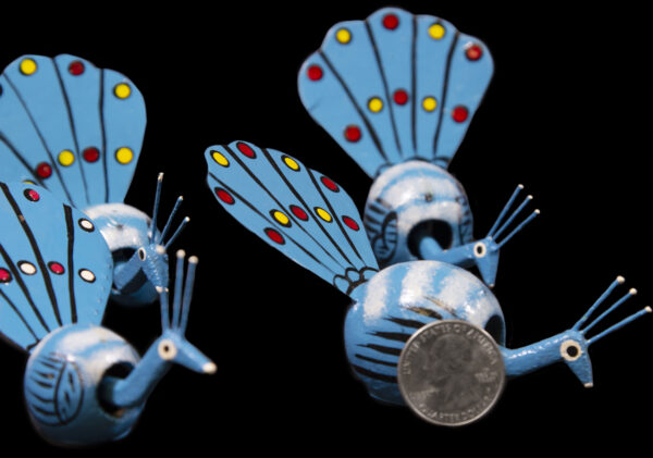 Blue Looseneck Peacock Figurines with quarter for size comparison