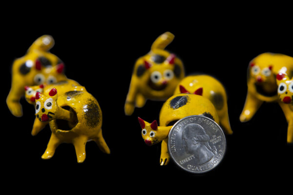 Yellow Looseneck Cat Figurines with quarter for size comparison