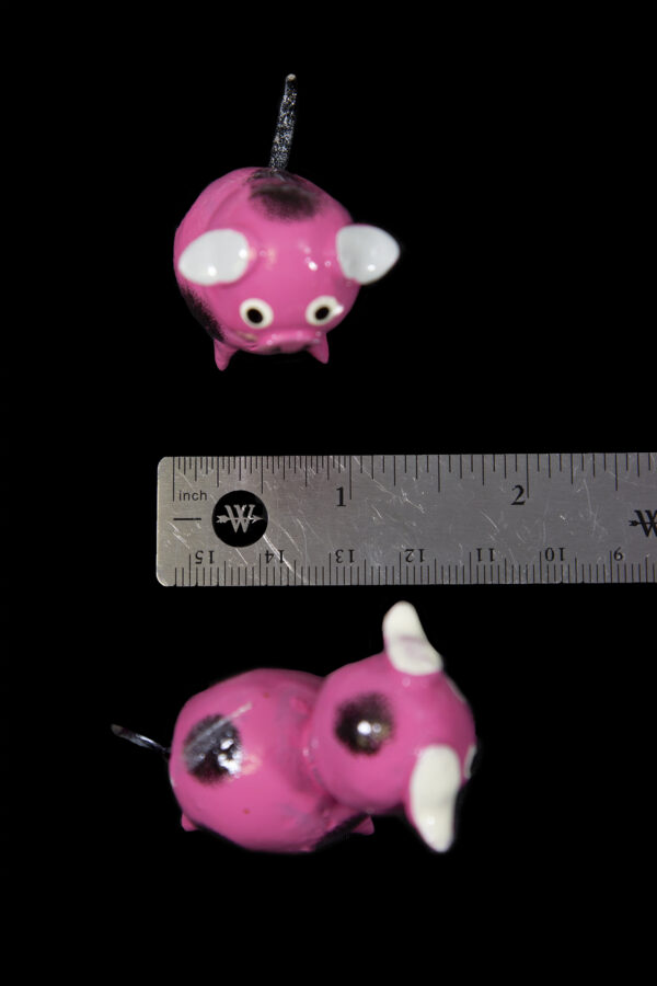 Pink Looseneck Pig Figurines next to ruler for size comparison