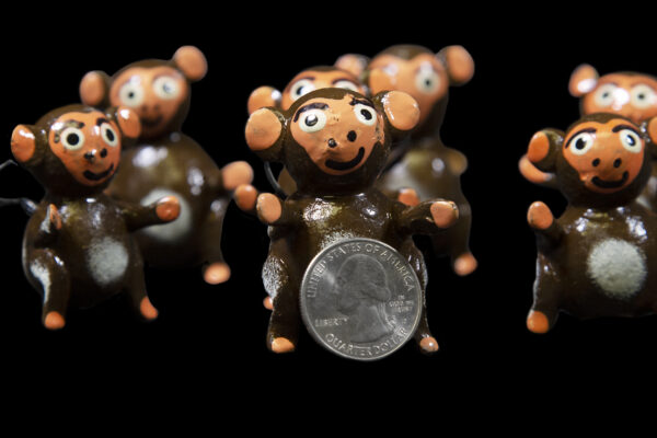Looseneck Monkey Figurines with quarter for size comparison