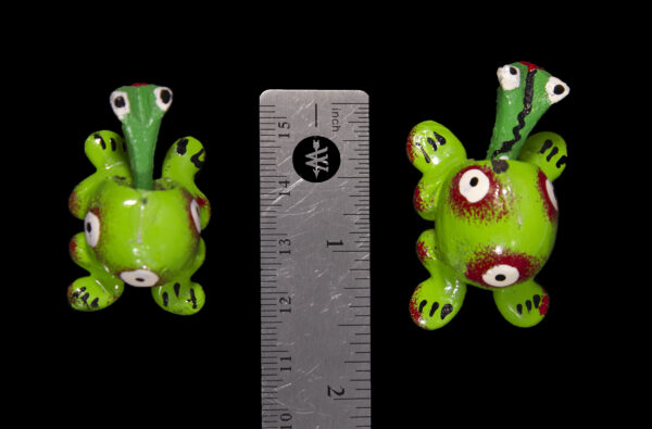 Green Looseneck Frog Figurines next to ruler for size comparison
