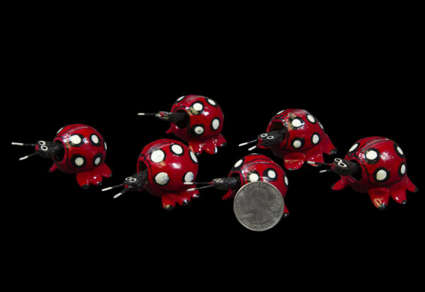 Red Looseneck Ladybug Figurines with quarter for size comparison